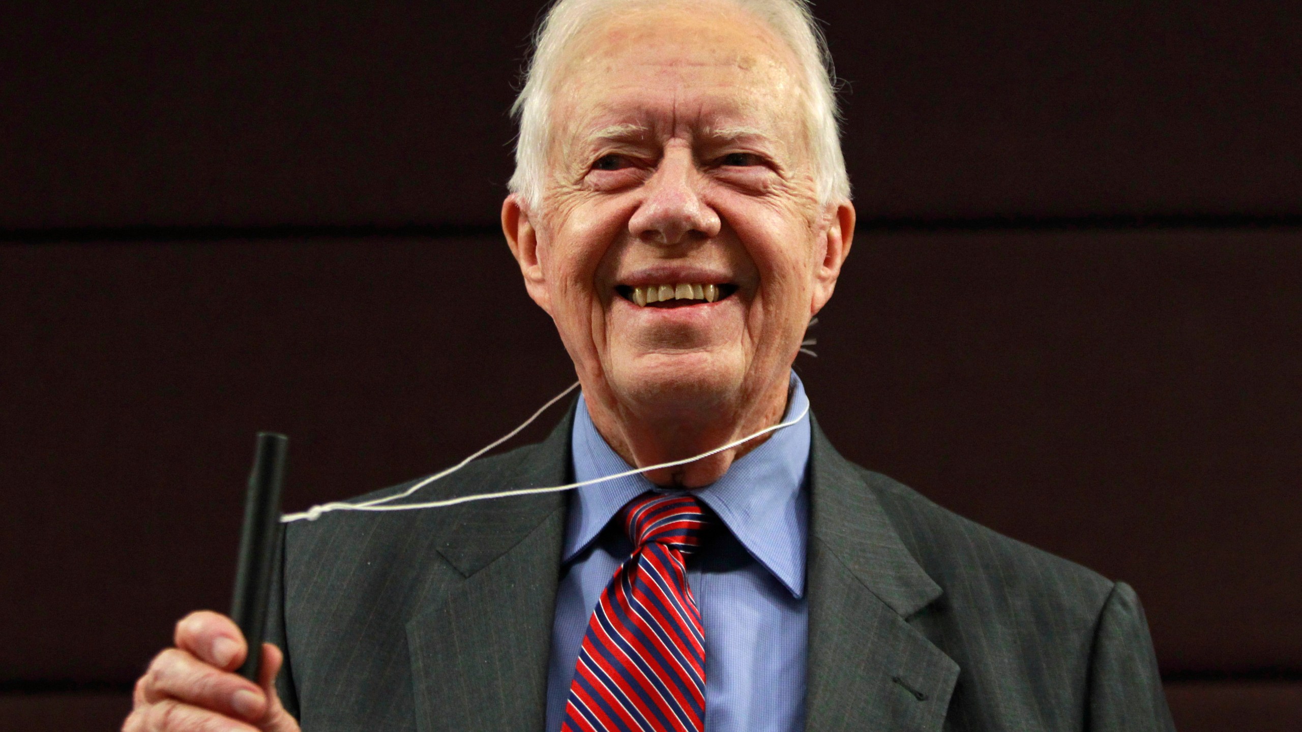 FILE - Former U.S. President Jimmy Carter poses for photographers with a water pipe filter, that is used to combat guinea worm disease, during a news conference to mark the launch of a campaign to eradicate the disease in central London, Wednesday, Oct. 5, 2011. (AP Photo/Lefteris Pitarakis, File)