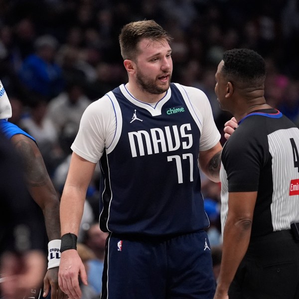 Dallas Mavericks guard Luka Doncic (77) questions a call by referee Sean Wright (4) during the first half of an NBA basketball game against the Portland Trail Blazers, Monday, Dec. 23, 2024, in Dallas. (AP Photo/LM Otero)