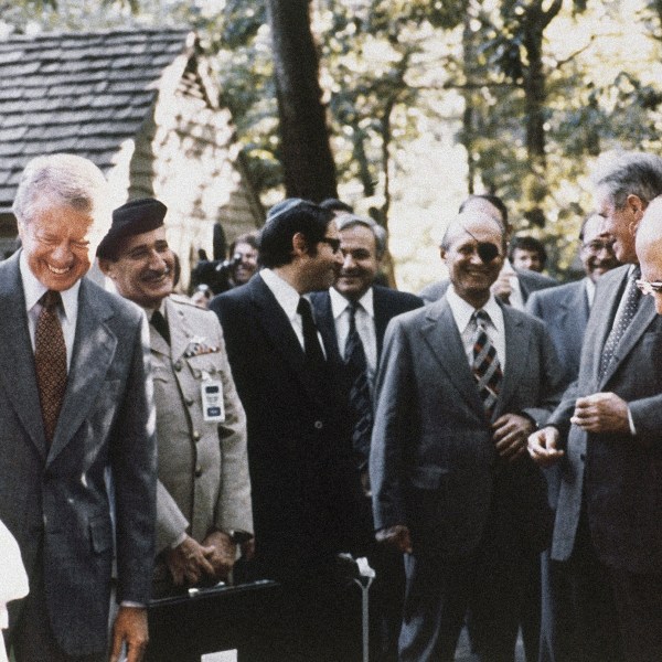 FILE - President Jimmy Carter, Israeli Premier Menachem Begin and Egyptian President Anwar Sadat gather with their aides during discussions on Middle East problems at Camp David, Md., in September 1978. (AP Photo, File)