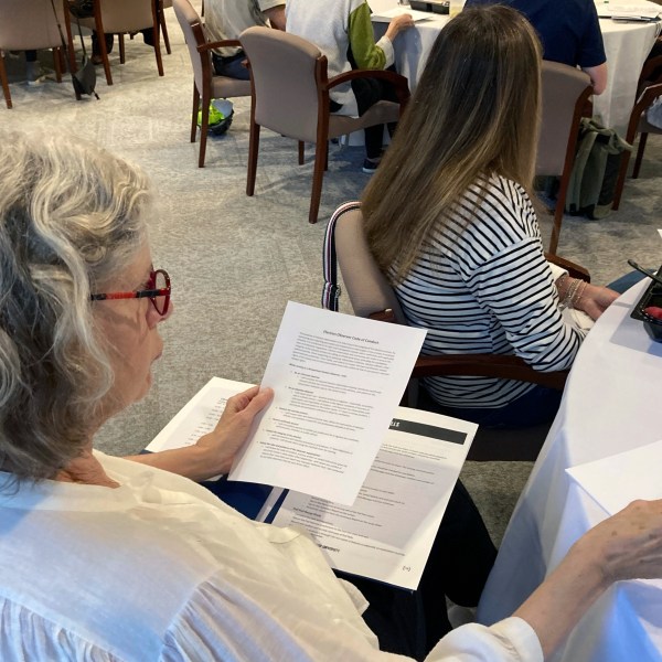 FILE - A volunteer election observer reviews training materials on Nov. 6, 2022, at the Carter Center in Atlanta. (AP Photo/Jeff Amy, File)