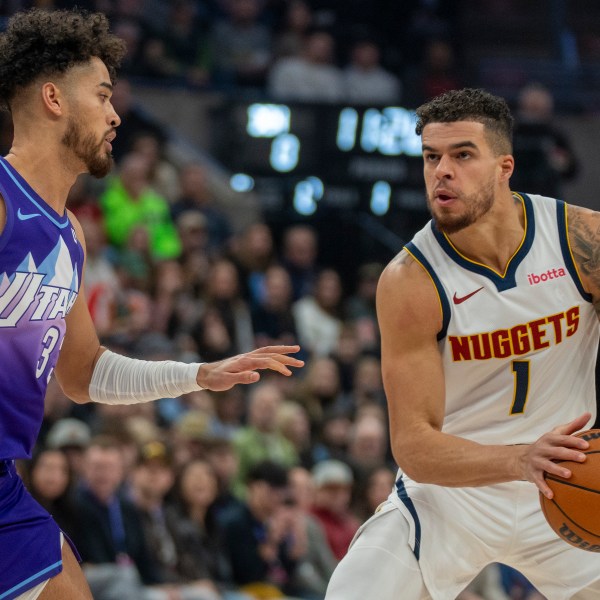 Denver Nuggets forward Michael Porter Jr. (1) looks to shoot as Utah Jazz guard Johnny Juzang, left, defends during the first half of an NBA basketball game Monday, Dec. 30, 2024, in Salt Lake City. (AP Photo/Rick Egan)