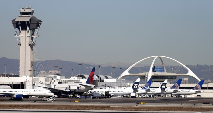 FILE - Airplanes sit on the tarmac at Los Angeles International Airport Friday, Nov. 1, 2013. (AP Photo/Gregory Bull, File)