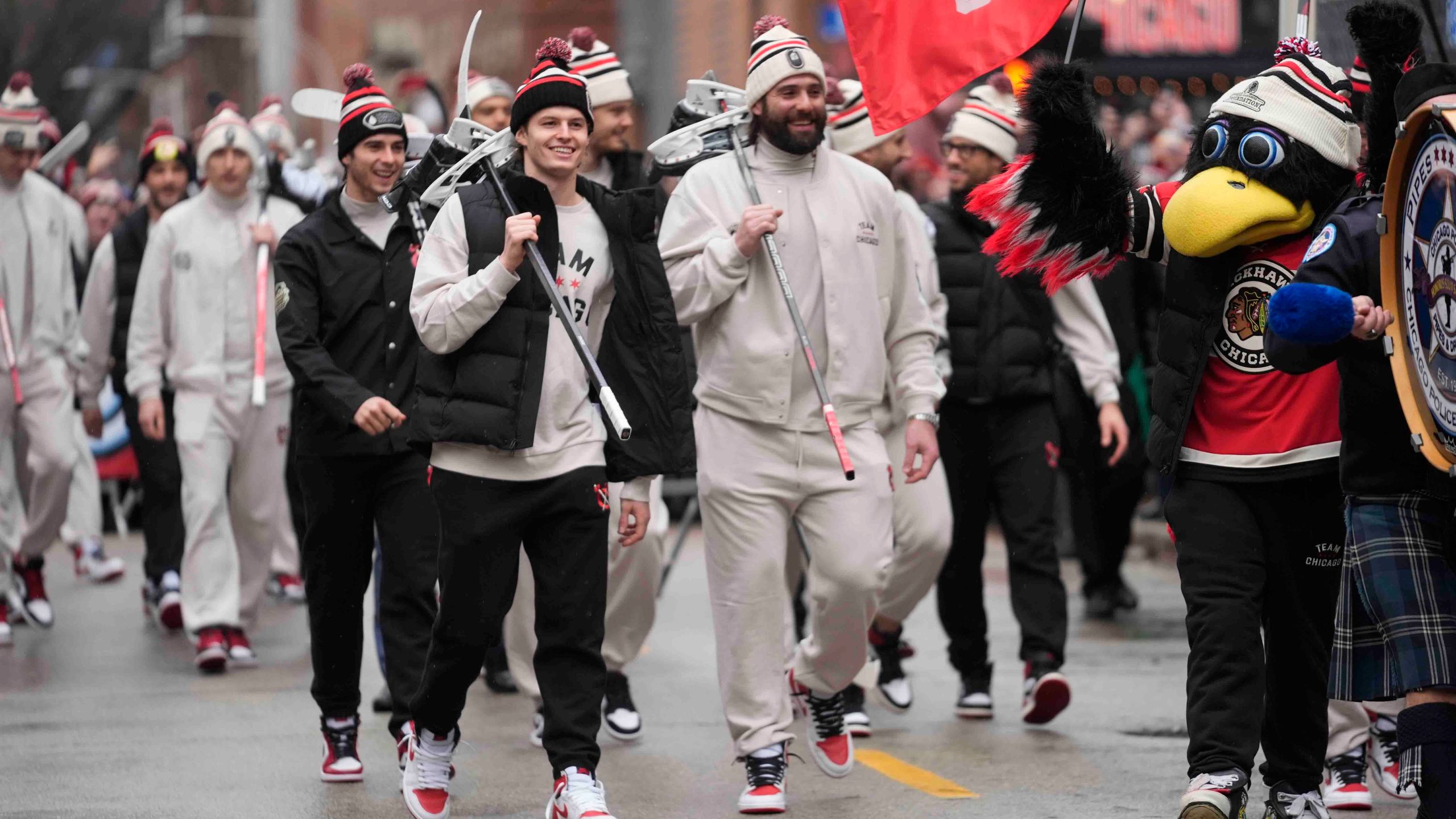 Chicago Blackhawks left wing Lukas Reichel, left, and left wing Patrick Maroon arrive with the team for the NHL Winter Classic outdoor hockey game featuring the Blackhawks and St. Louis Blues at Wrigley Field, Tuesday, Dec. 31, 2024, in Chicago. (AP Photo/Erin Hooley)