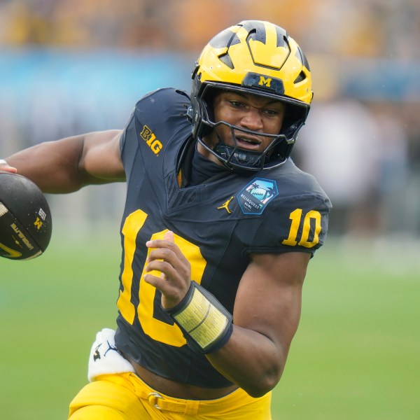 Michigan quarterback Alex Orji picks up yards against Alabama during the first half of the ReliaQuest Bowl NCAA college football game Tuesday, Dec. 31, 2024, in Tampa, Fla. (AP Photo/Chris O'Meara)