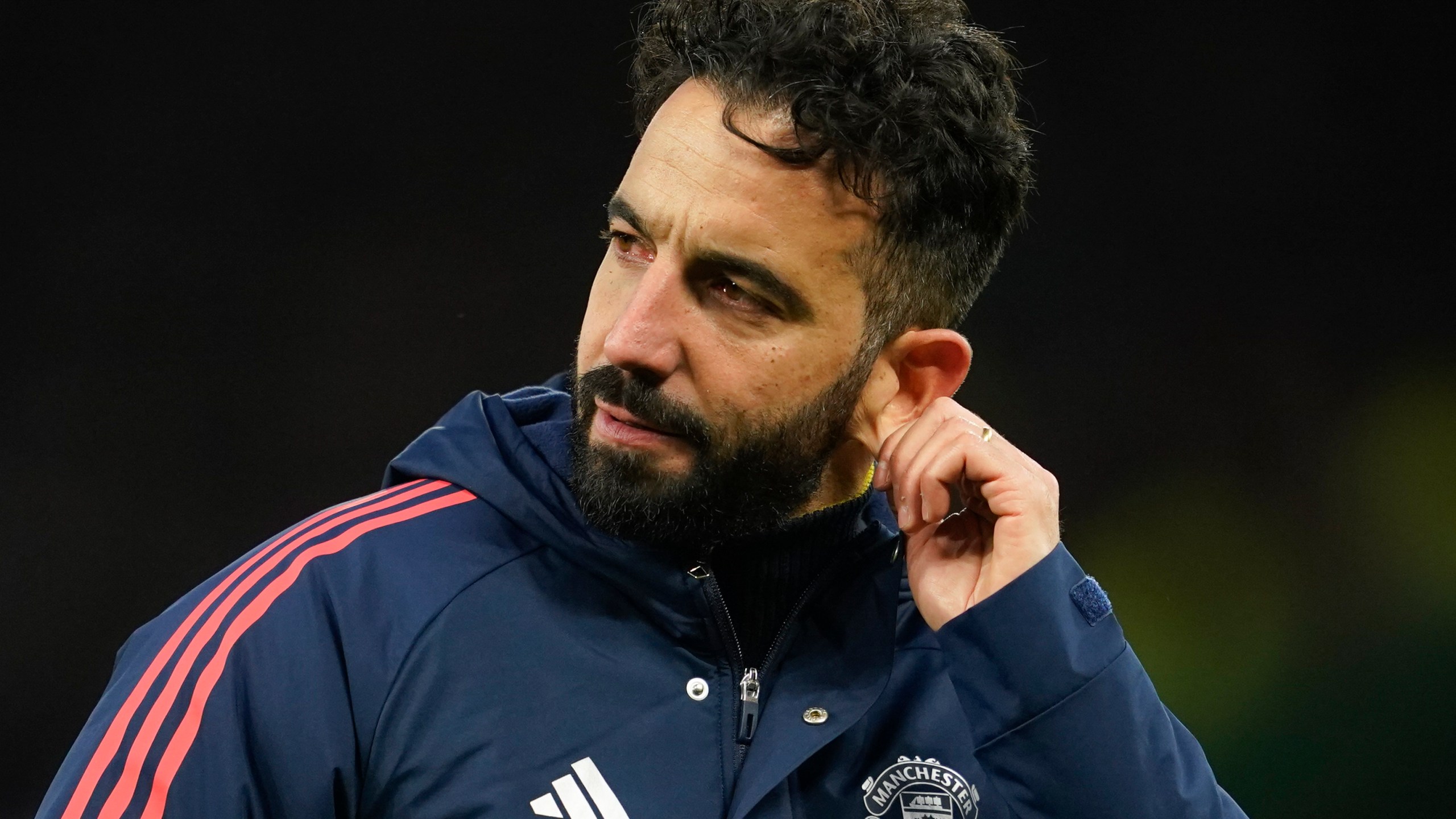 Manchester United's head coach Ruben Amorim pulls on his ear after the English Premier League soccer match between Manchester United and Bournemouth at the Old Trafford stadium in Manchester, England, Sunday, Dec. 22, 2024. (AP Photo/Dave Thompson)