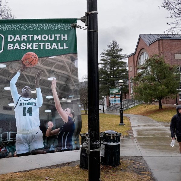 FILE - A student walks near the Alumni Gymnasium on the campus of Dartmouth College, March 5, 2024, in Hanover, N.H. (AP Photo/Robert F. Bukaty, File)