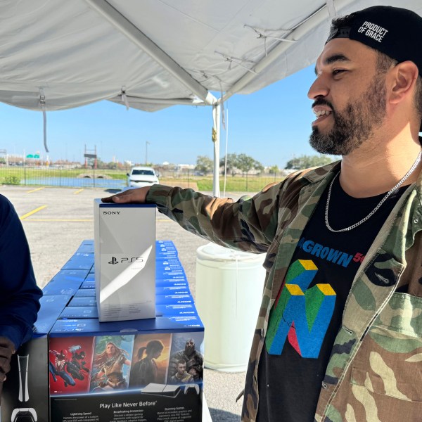 J.D. Carrere, co-director of the NOLA Grown gaming program, right, attends a city-supported gun buyback program Tuesday, Dec. 31, 2024, in New Orleans. Carrere has helped organize a series of gun buybacks after Louisiana loosened gun ownership restrictions. (AP Photo/Jack Brook)