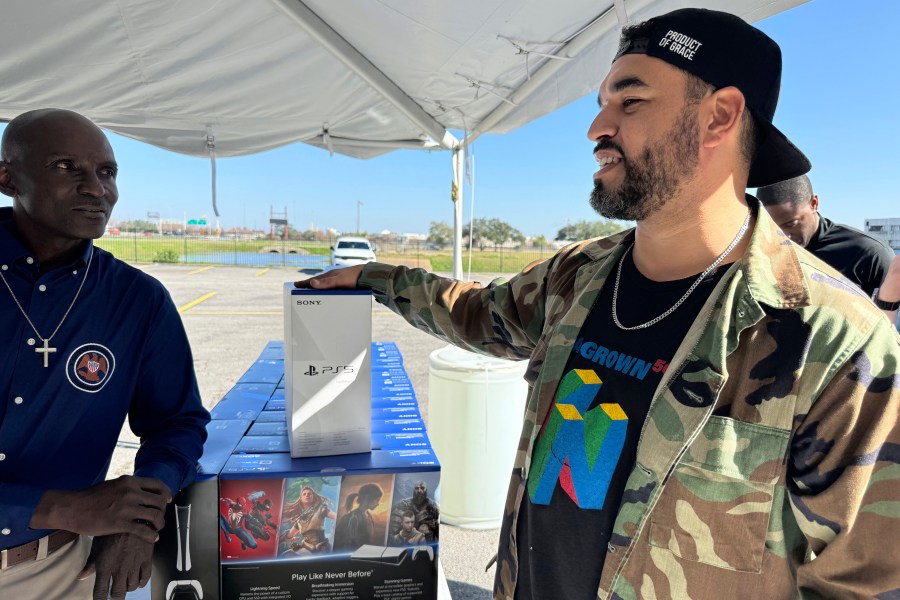 J.D. Carrere, co-director of the NOLA Grown gaming program, right, attends a city-supported gun buyback program Tuesday, Dec. 31, 2024, in New Orleans. Carrere has helped organize a series of gun buybacks after Louisiana loosened gun ownership restrictions. (AP Photo/Jack Brook)