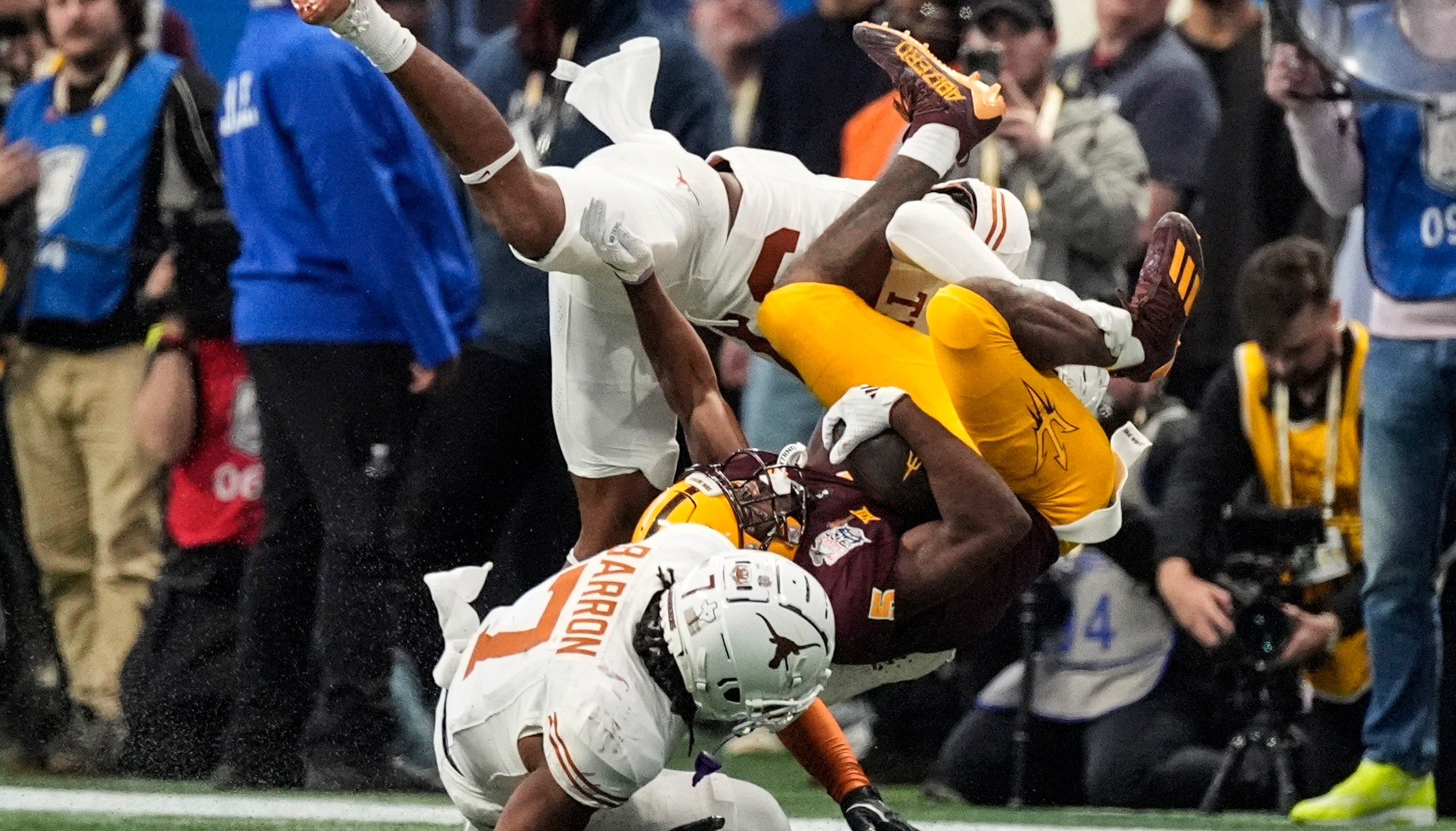 Texas linebacker Morice Blackwell Jr. (37) hits Arizona State wide receiver Melquan Stovall (5) during the first half in the quarterfinals of a College Football Playoff, Wednesday, Jan. 1, 2025, in Atlanta. (AP Photo/John Bazemore)