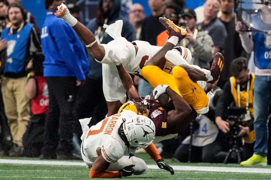 Texas linebacker Morice Blackwell Jr. (37) hits Arizona State wide receiver Melquan Stovall (5) during the first half in the quarterfinals of a College Football Playoff, Wednesday, Jan. 1, 2025, in Atlanta. (AP Photo/John Bazemore)