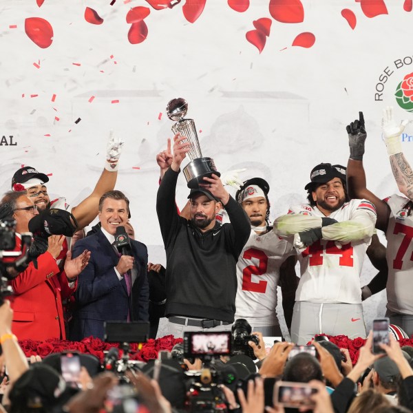 Ohio State head coach Ryan Day celebrates with the trophy alongside his team after winning the Rose Bowl College Football Playoff against Oregon, Wednesday, Jan. 1, 2025, in Pasadena, Calif. (AP Photo/Mark J. Terrill)