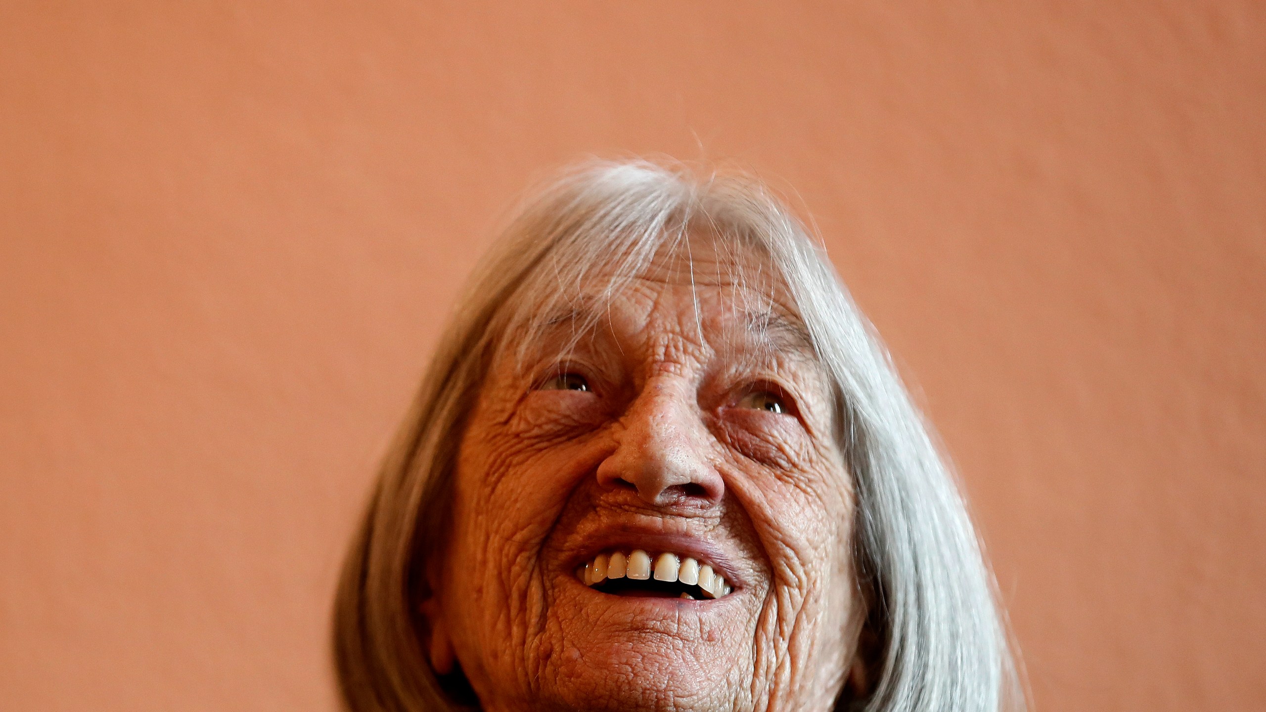 FILE - Agnes Keleti, former Olympic gold medal winning gymnast, smiles at her apartment in Budapest, Hungary Wednesday Jan. 8, 2020. (AP Photo/Laszlo Balogh, File)