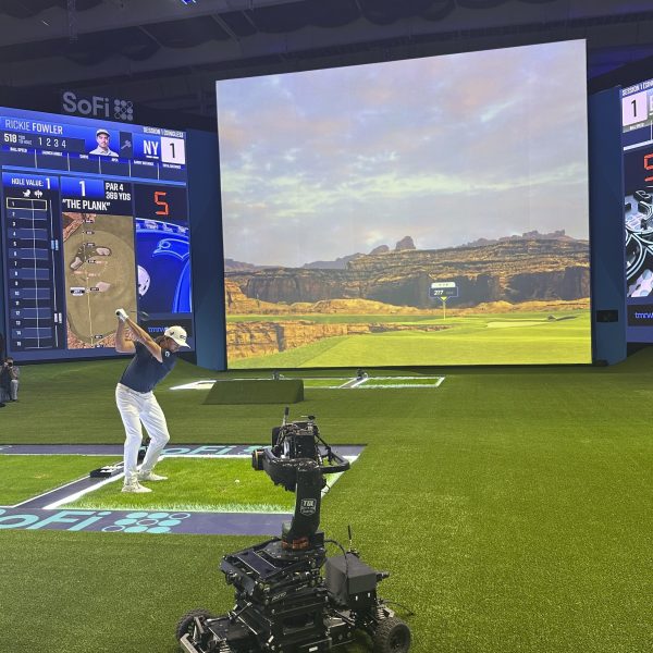 Rickie Fowler hits into the massive simulator screen at the SoFi Center in Palm Beach Gardens, Fla, on Dec. 18, 2024. The 250,000-square-foot complex holds the new TMRW Golf League co-owned by Tiger Woods and Rory McIlroy. The first match is Jan. 7, 2025 in prime time on ESPN. (AP Photo/Doug Ferguson)