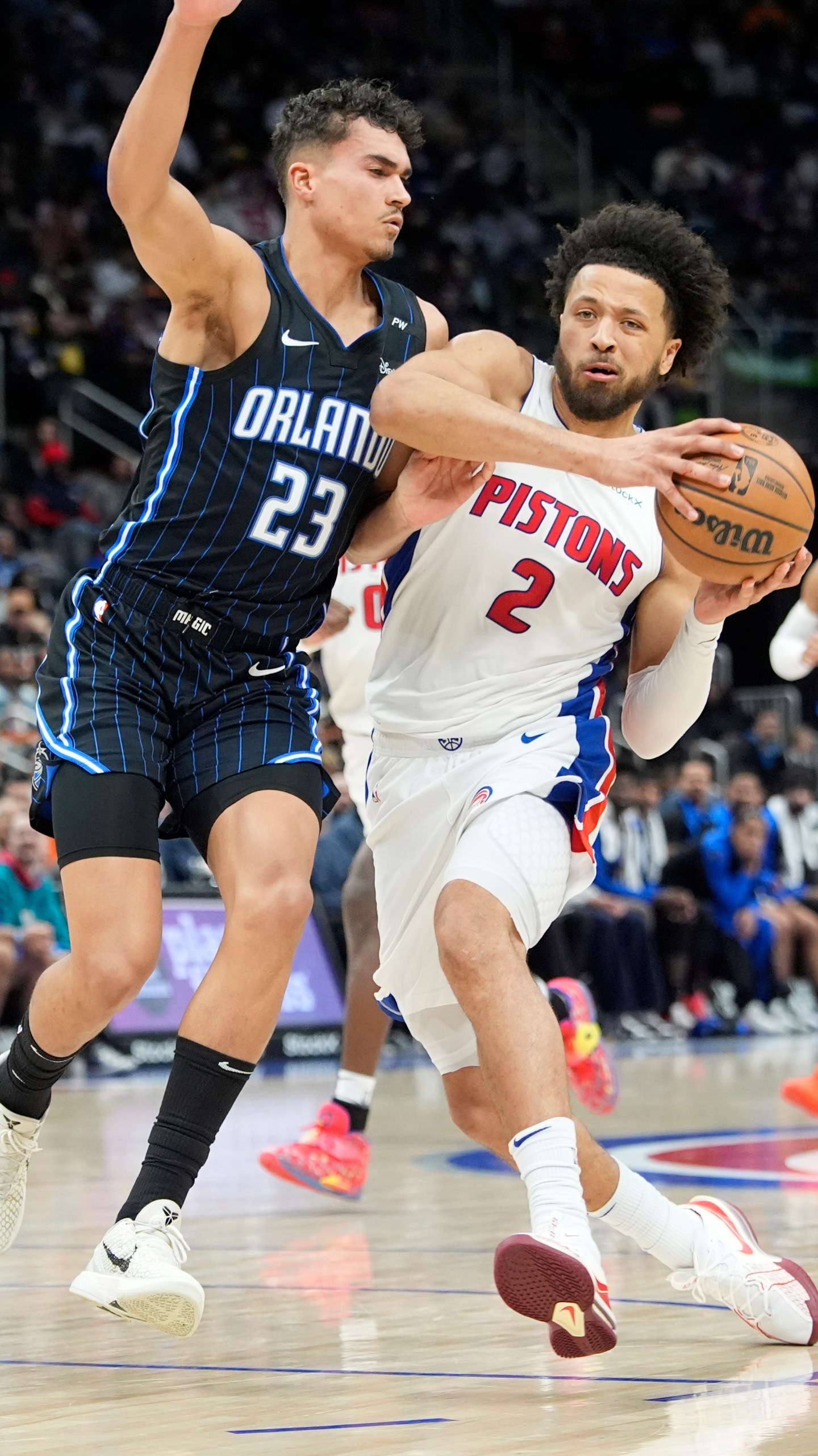 Detroit Pistons guard Cade Cunningham (2) drives as Orlando Magic forward Tristan da Silva (23) defends during the first half of an NBA basketball game, Wednesday, Jan. 1, 2025, in Detroit. (AP Photo/Carlos Osorio)