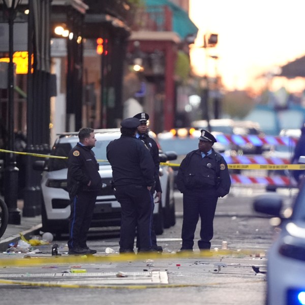 Emergency services attend the scene on Bourbon Street after a vehicle drove into a crowd on New Orleans' Canal and Bourbon Street, Wednesday Jan. 1, 2025. (AP Photo/Gerald Herbert)