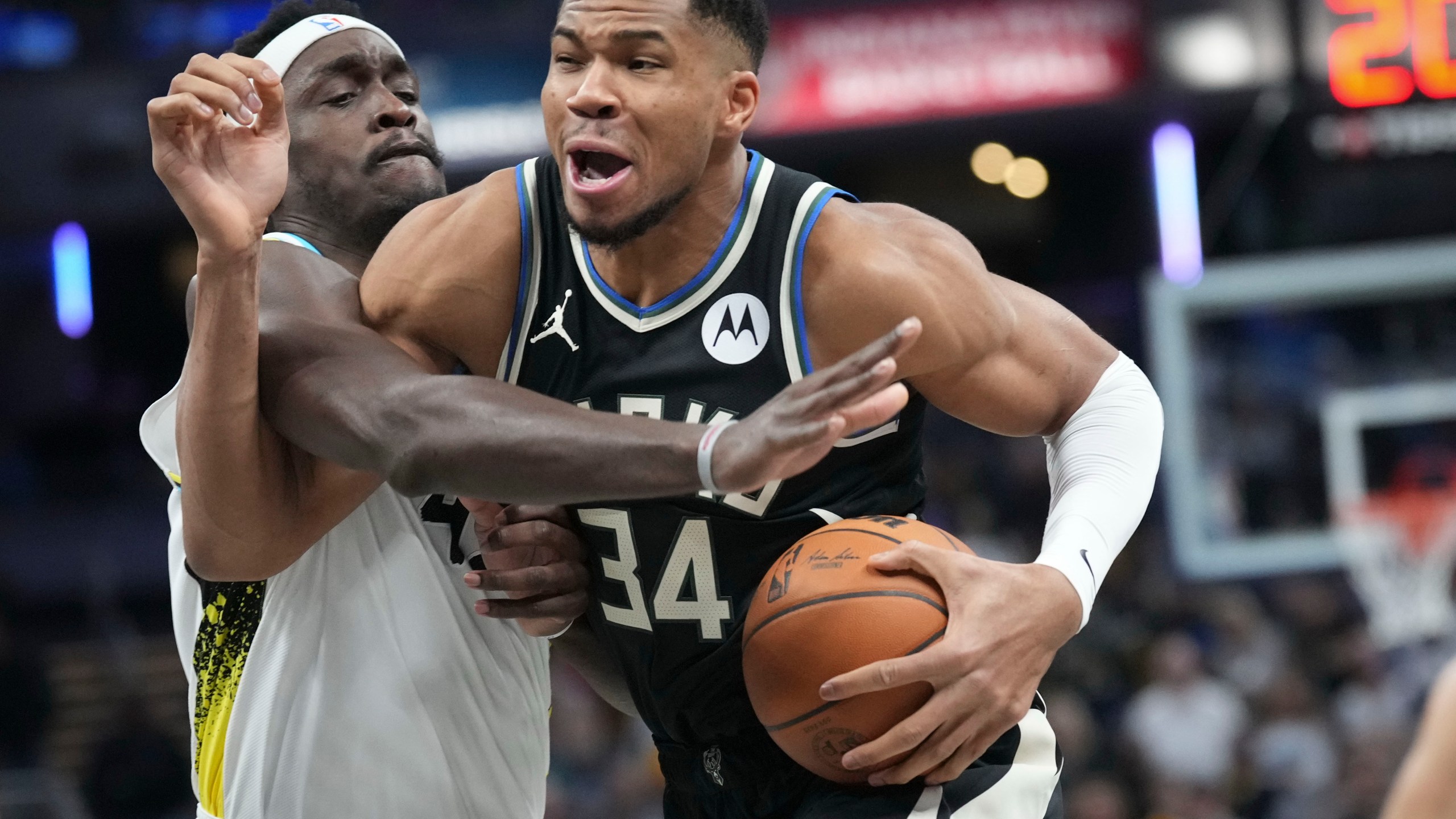 Milwaukee Bucks forward Giannis Antetokounmpo, right, goes around Indiana Pacers forward Pascal Siakam (43) during the first half of an NBA basketball game in Indianapolis, Tuesday, Dec. 31, 2024. (AP Photo/AJ Mast)