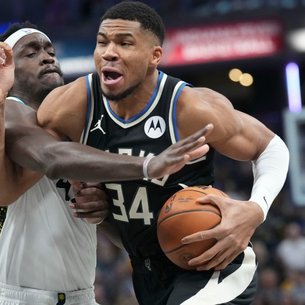 Milwaukee Bucks forward Giannis Antetokounmpo, right, goes around Indiana Pacers forward Pascal Siakam (43) during the first half of an NBA basketball game in Indianapolis, Tuesday, Dec. 31, 2024. (AP Photo/AJ Mast)