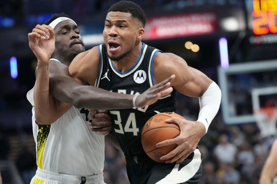 Milwaukee Bucks forward Giannis Antetokounmpo, right, goes around Indiana Pacers forward Pascal Siakam (43) during the first half of an NBA basketball game in Indianapolis, Tuesday, Dec. 31, 2024. (AP Photo/AJ Mast)