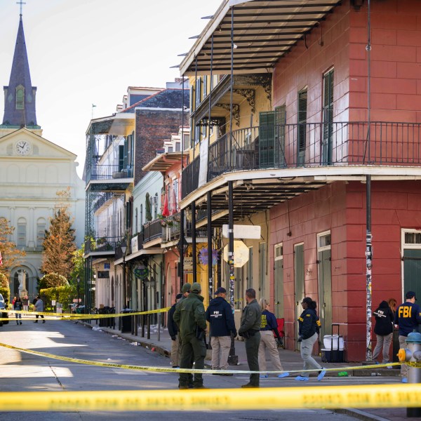 The FBI investigates the area on Orleans St and Bourbon Street by St. Louis Cathedral in the French Quarter where a suspicious package was detonated after a person drove a truck into a crowd earlier on Bourbon Street on Wednesday, Jan. 1, 2025. (AP Photo/Matthew Hinton)