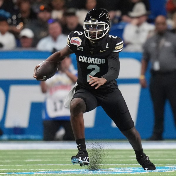 Colorado quarterback Shedeur Sanders (2) scramble for yardage against BYU during the first half of the Alamo Bowl NCAA college football game, Saturday, Dec. 28, 2024, in San Antonio. (AP Photo/Eric Gay)