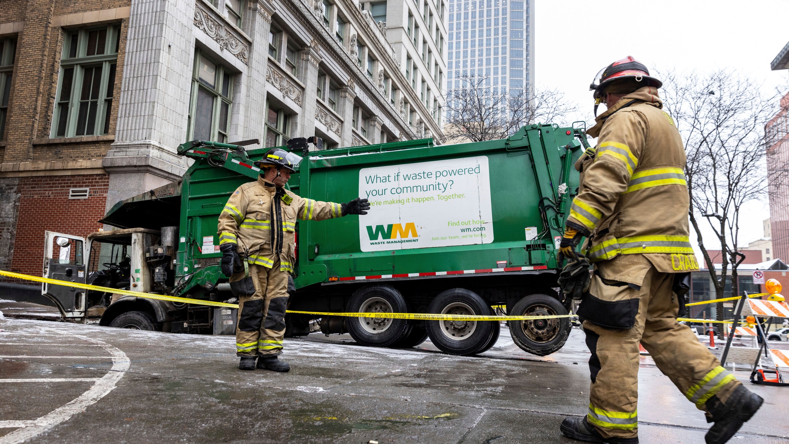 The Omaha Fire Department is on the scene where a garbage truck got stuck in a sinkhole in downtown Omaha, Neb., Thursday, Jan. 2, 2025. (Chris Machian/Omaha World-Herald via AP)