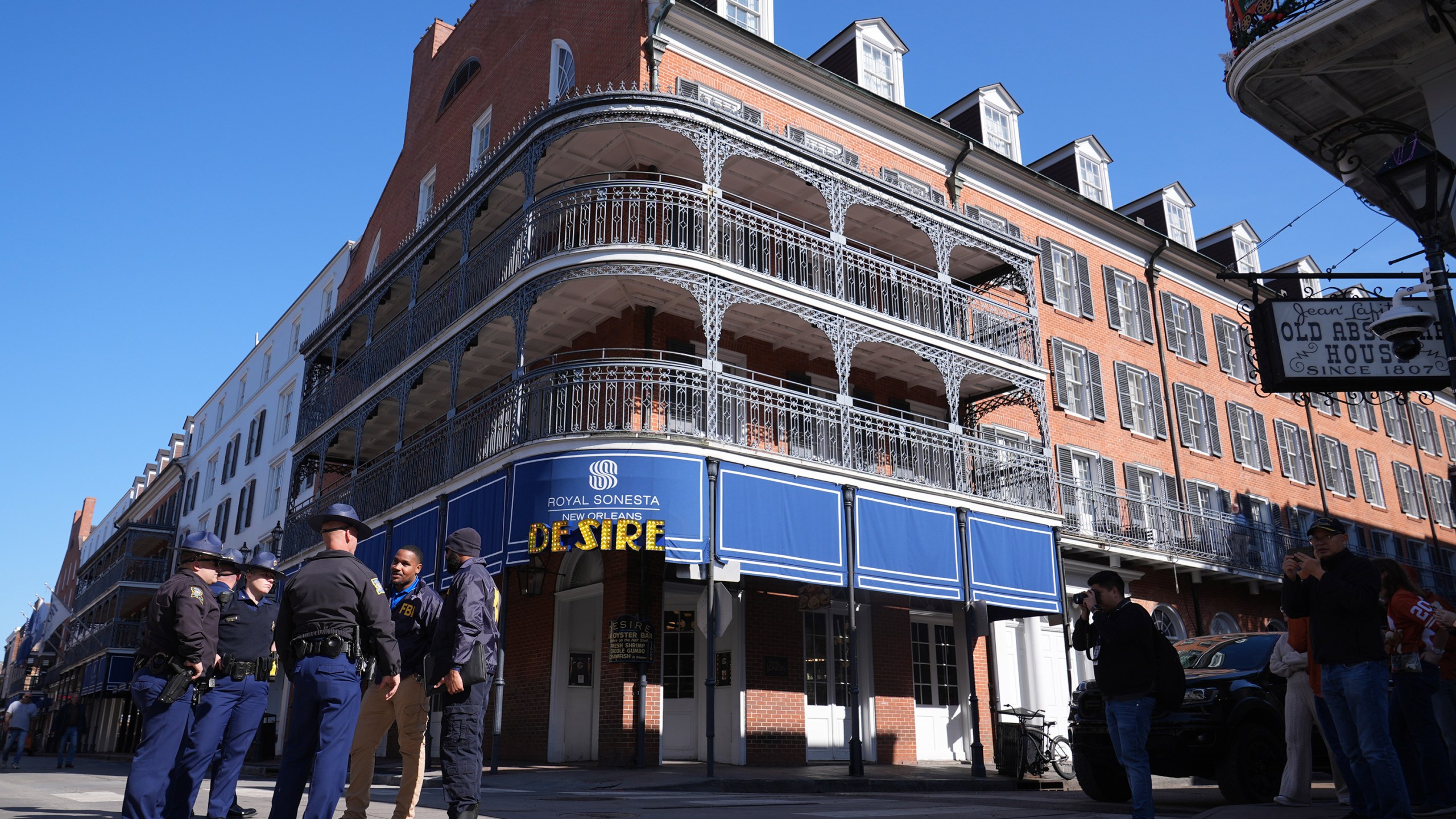 Law enforcement gather in front of the Sonesta Hotel on Bourbon Street, Thursday, Jan. 2, 2025 in New Orleans. (AP Photo/George Walker IV)