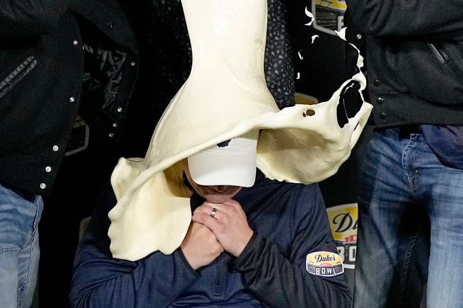 FILE - West Virginia head coach Neal Brown is dunked with mayonnaise after the team's win against North Carolina in an NCAA college football game at the Duke's Mayo Bowl Wednesday, Dec. 27, 2023, in Charlotte, N.C. (AP Photo/Chris Carlson, File)