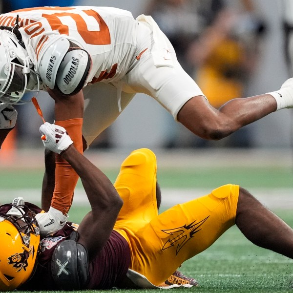 Arizona State wide receiver Melquan Stovall (5) and Texas defensive back Warren Roberson (24) collide during the first half in the quarterfinals of a College Football Playoff, Wednesday, Jan. 1, 2025, in Atlanta. (AP Photo/John Bazemore)