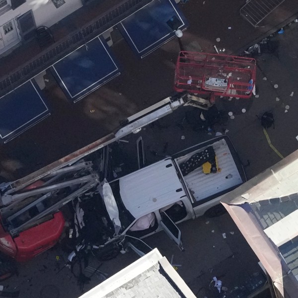 Investigators work the scene after a person drove a vehicle into a crowd earlier on Canal and Bourbon Street in New Orleans, Wednesday, Jan. 1, 2025. (AP Photo/Gerald Herbert)