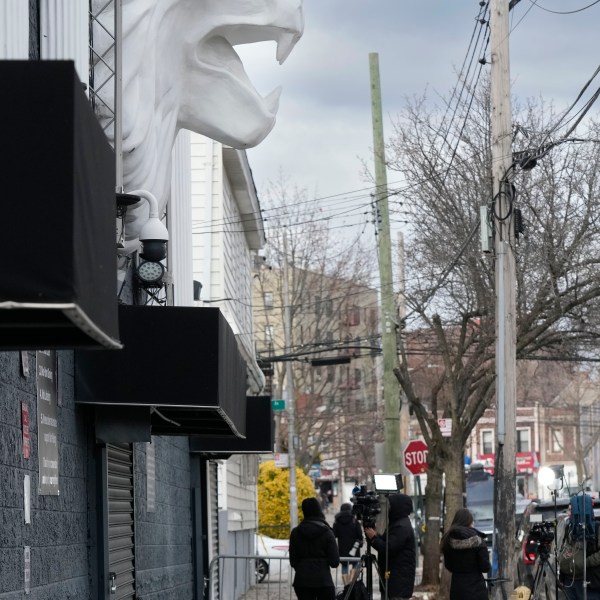 Members of the media work in front of the nightclub Amazura, left, in the Queens borough of New York, Thursday, Jan. 2, 2025. (AP Photo/Seth Wenig)