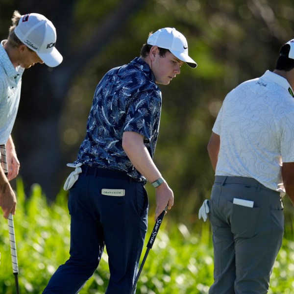 From left; Will Zalatoris, Robert MacIntyre, of Scotland, and Si Woo Kim, of South Korea, walks across the fourth green during the first round of The Sentry golf event, Thursday, Jan. 2, 2025, at Kapalua Plantation Course in Kapalua, Hawaii. (AP Photo/Matt York)