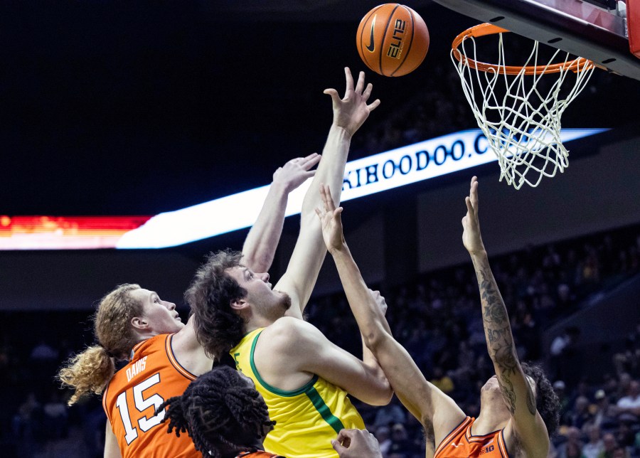 Oregon center Nate Bittle (32) shoot against Illinois forward Will Riley (7) during the first half of an NCAA college basketball game in Eugene, Ore., Thursday, Jan. 2, 2025. (AP Photo/Thomas Boyd)