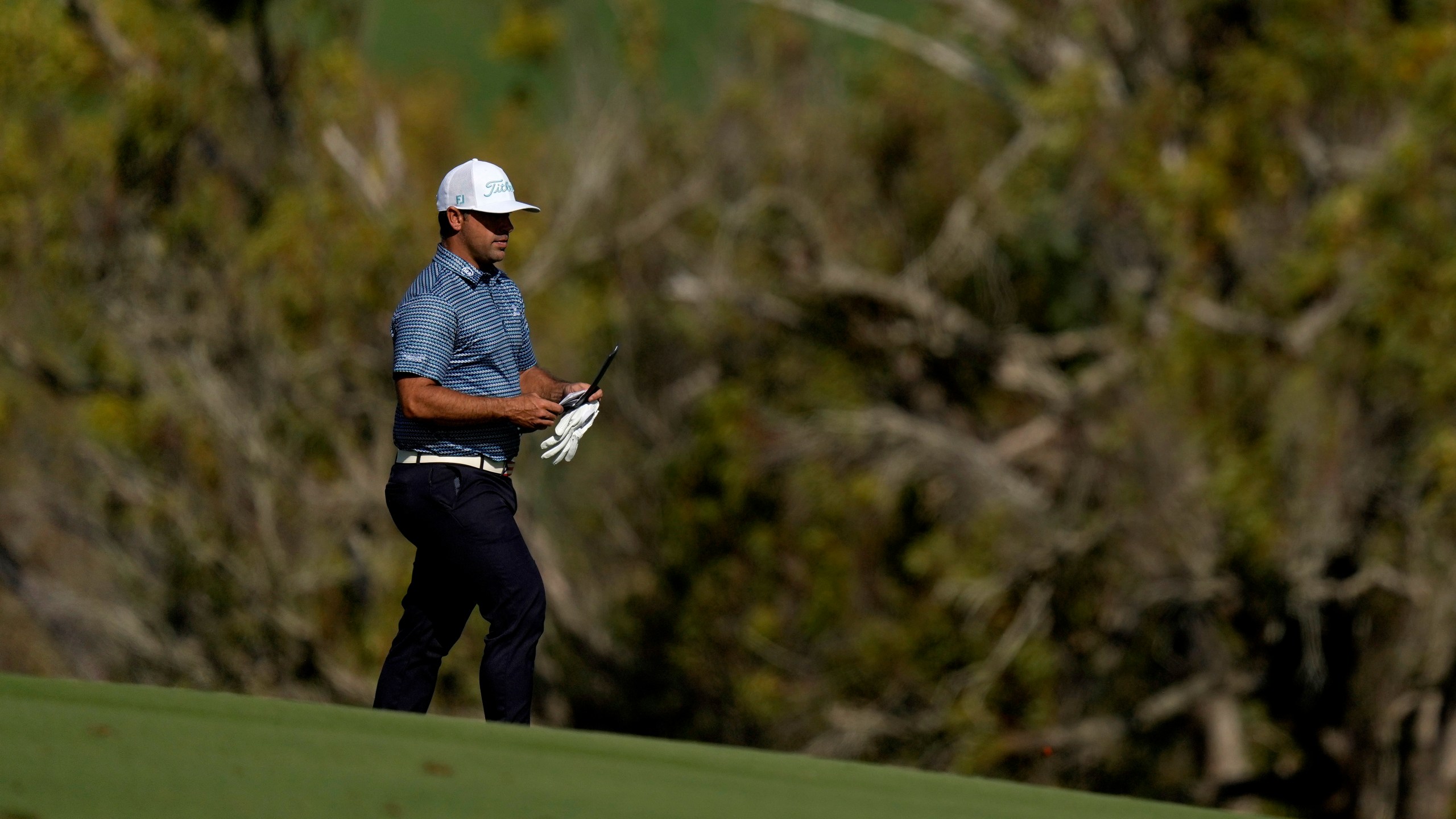 Rafael Campos, of Puerto Rico, walks to his ball on the fourth fairway during the first round of The Sentry golf event, Thursday, Jan. 2, 2025, at Kapalua Plantation Course in Kapalua, Hawaii. (AP Photo/Matt York)