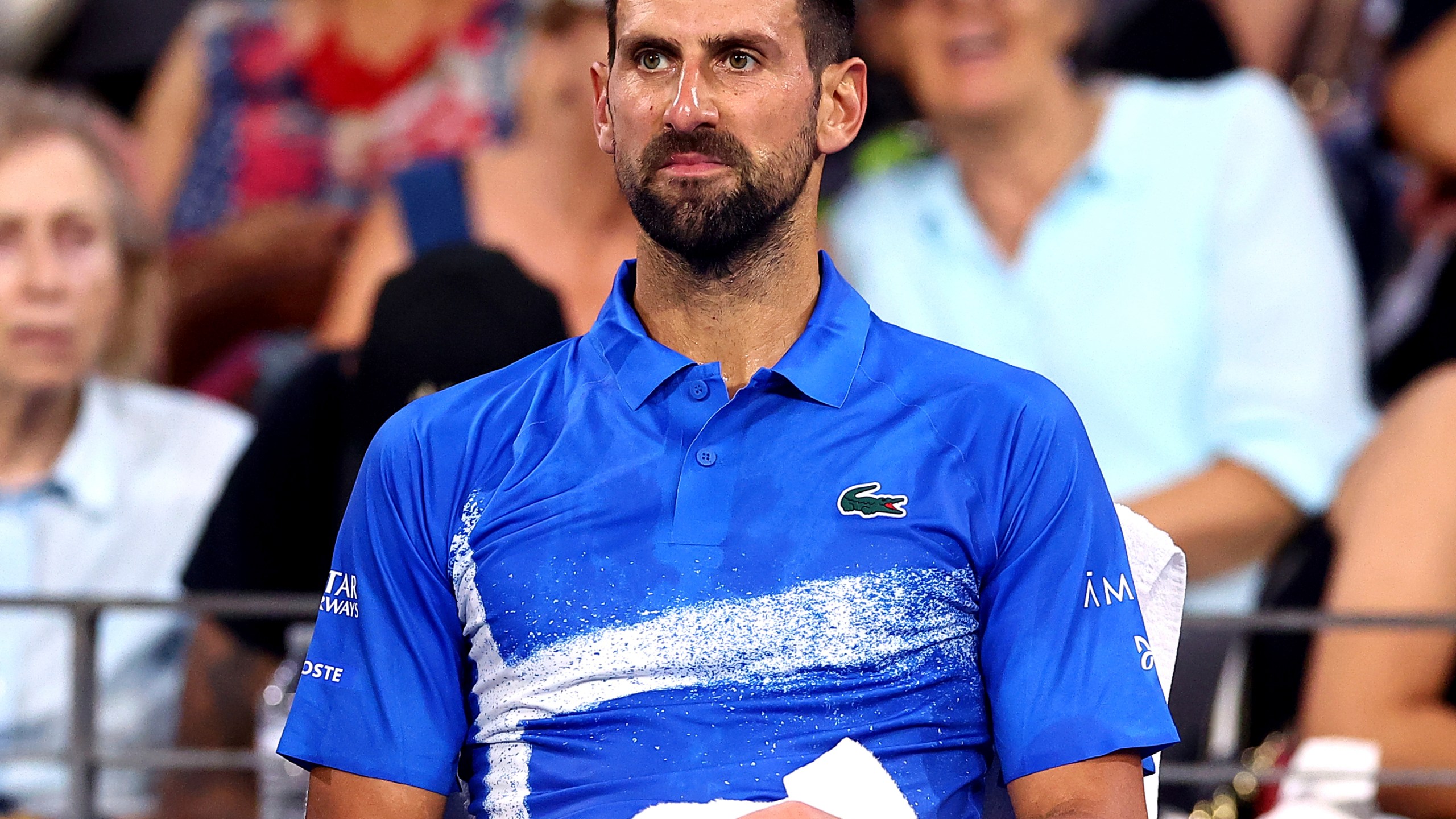 Serbia's Novak Djokovic looks on during his match against USA's Reilly Opelka at the Brisbane International, in Brisbane, Australia, Friday, Jan. 3, 2025. (AP Photo/Pat Hoelscher)