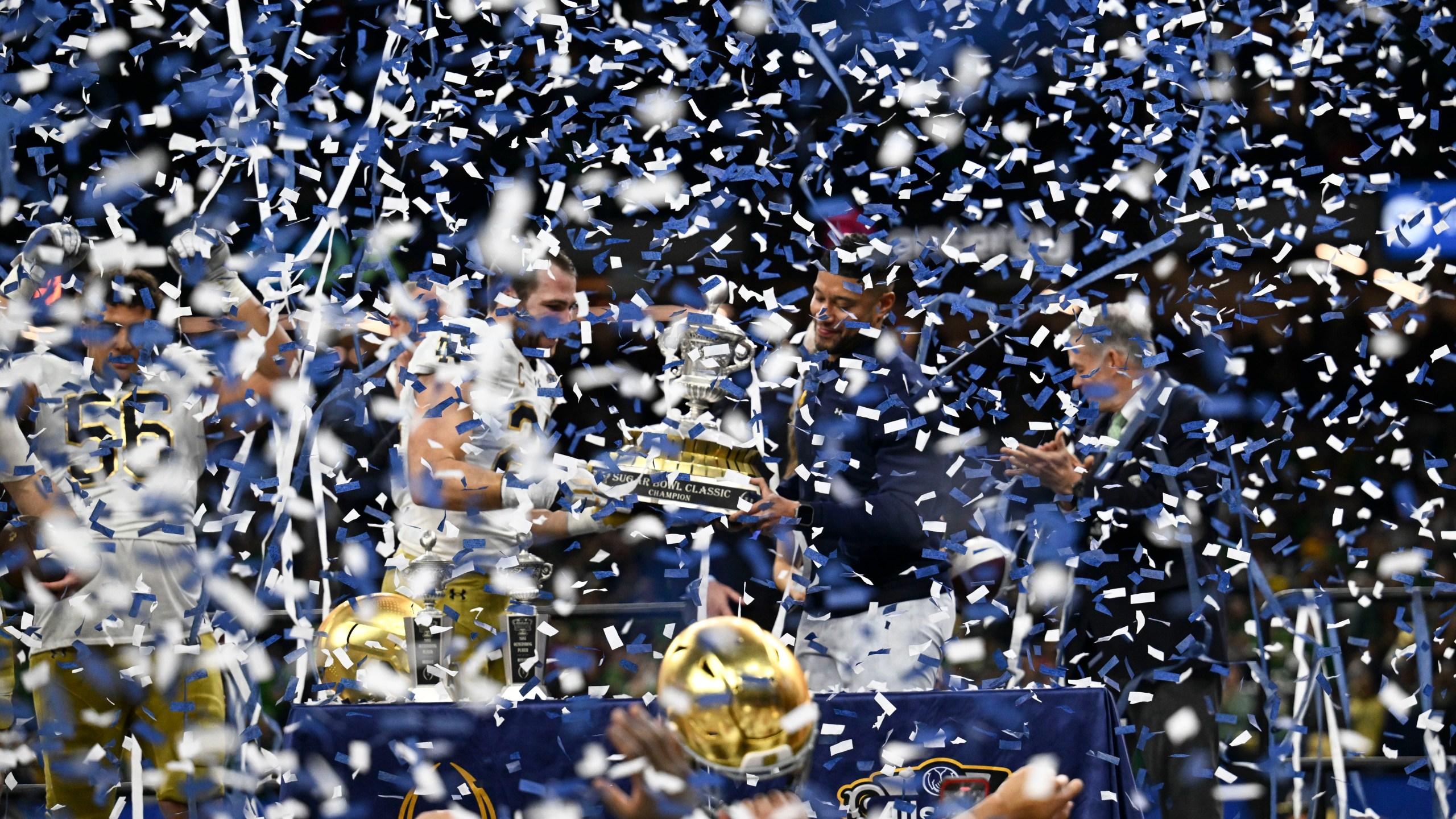 Notre Dame head coach Marcus Freeman celebrates with the trophy after a quarterfinal game against Georgia in a College Football Playoff, Thursday, Jan. 2, 2025, in New Orleans. (AP Photo/Matthew Hinton)