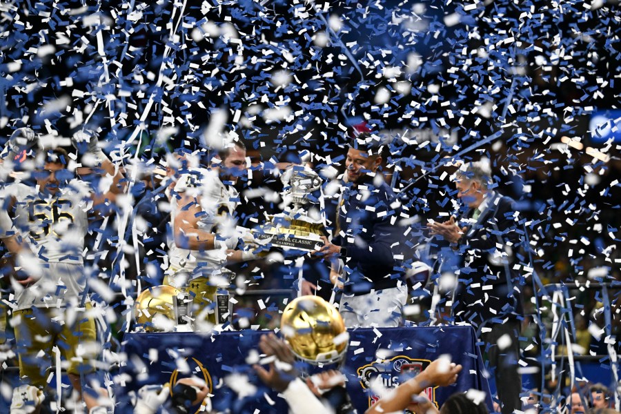 Notre Dame head coach Marcus Freeman celebrates with the trophy after a quarterfinal game against Georgia in a College Football Playoff, Thursday, Jan. 2, 2025, in New Orleans. (AP Photo/Matthew Hinton)