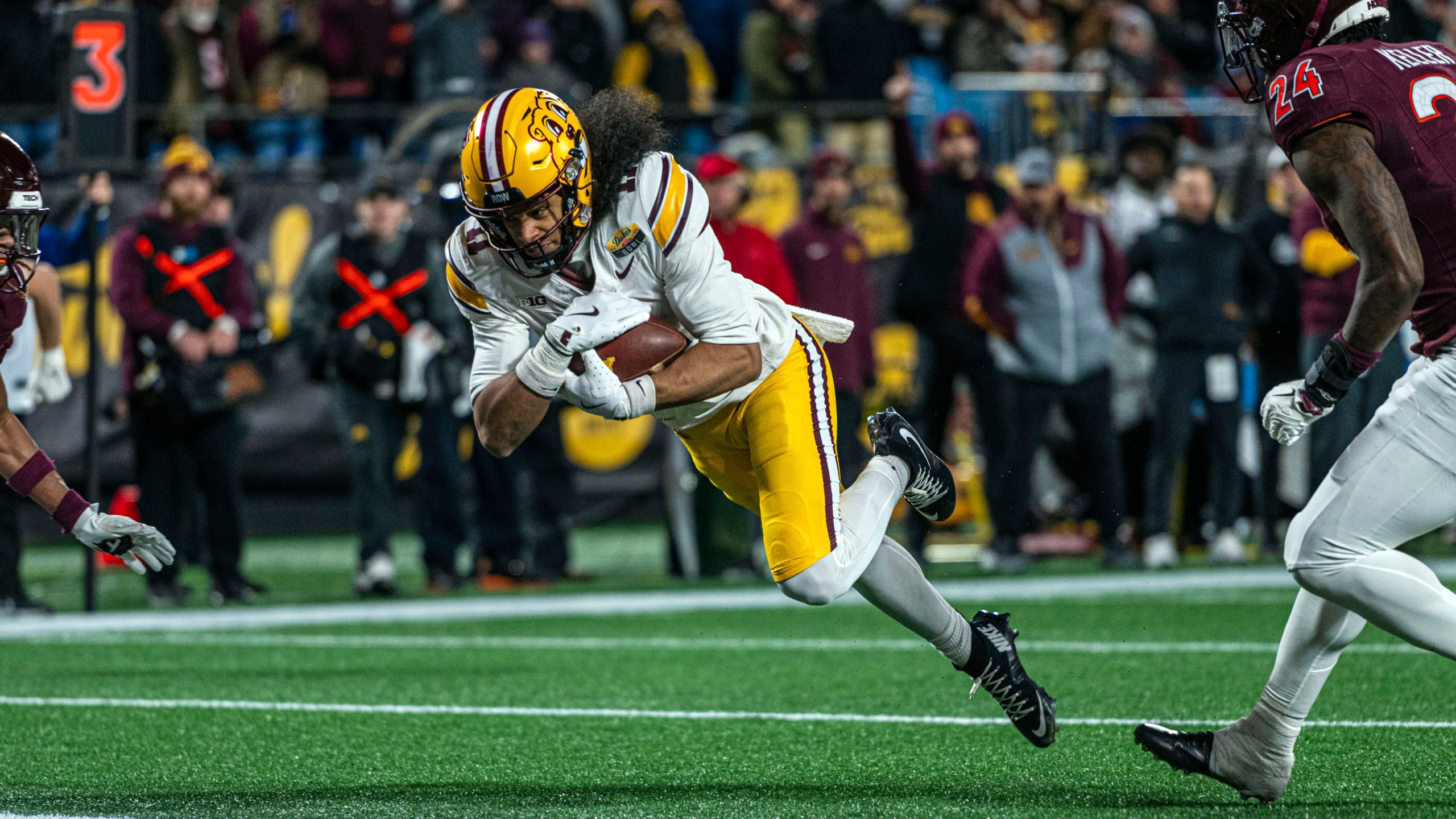 Minnesota wide receiver Elijah Spencer (11) dives in for a touchdown during the first half of the Duke's Mayo Bowl NCAA college football game Friday, Jan. 3, 2025, in Charlotte, N.C. (AP Photo/Robert Simmons)