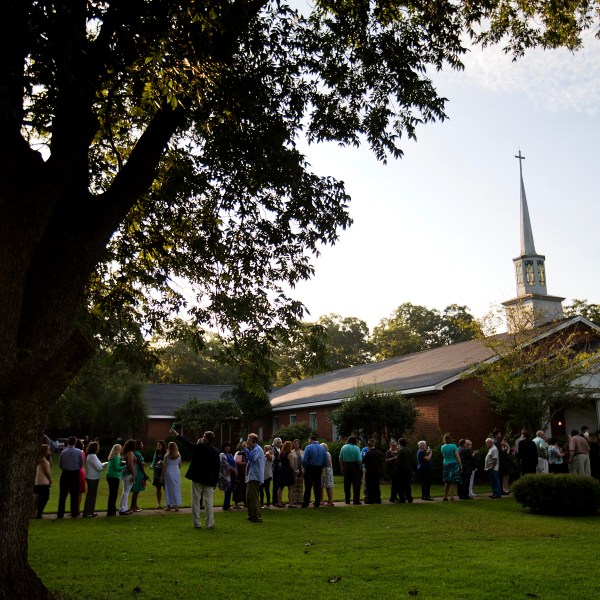 FILE - People wait in line outside Maranatha Baptist Church in Plains, Ga., to get into a Sunday school class taught by former U.S. President Jimmy Carter on Aug. 23, 2015. It was Carter's first lesson since announcing plans for intravenous drug doses and radiation to treat melanoma found in his brain after surgery to remove a tumor from his liver. (AP Photo/David Goldman, File)