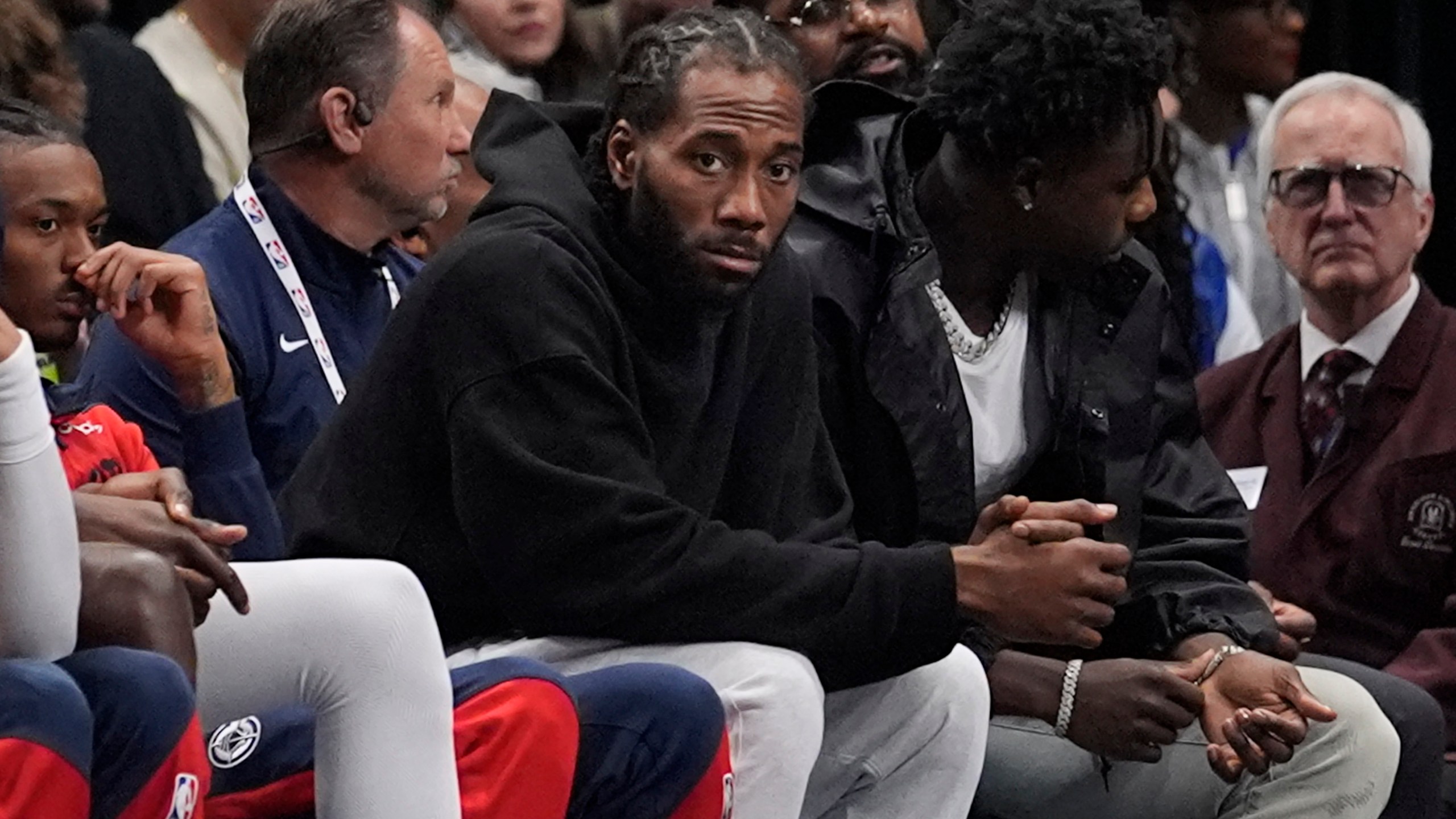 Los Angeles Clippers forward Kawhi Leonard watches from the bench during the first quarter of an NBA basketball game against the Dallas Mavericks, Saturday, Dec. 21, 2024, in Dallas. (AP Photo/LM Otero)