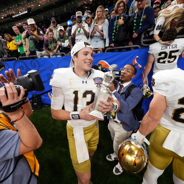 Notre Dame quarterback Riley Leonard (13) celebrates after a quarterfinal game against Georgia in a College Football Playoff, Thursday, Jan. 2, 2025, in New Orleans. (AP Photo/Gerald Herbert)