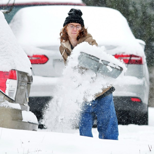 Elijah Minahan, of Johnstown, Pa., shovels out the driveway at his home in Westmont Borough as cold temperatures and snowfall hits the region on Friday, January 3, 2025. (Thomas Slusser/The Tribune-Democrat via AP)