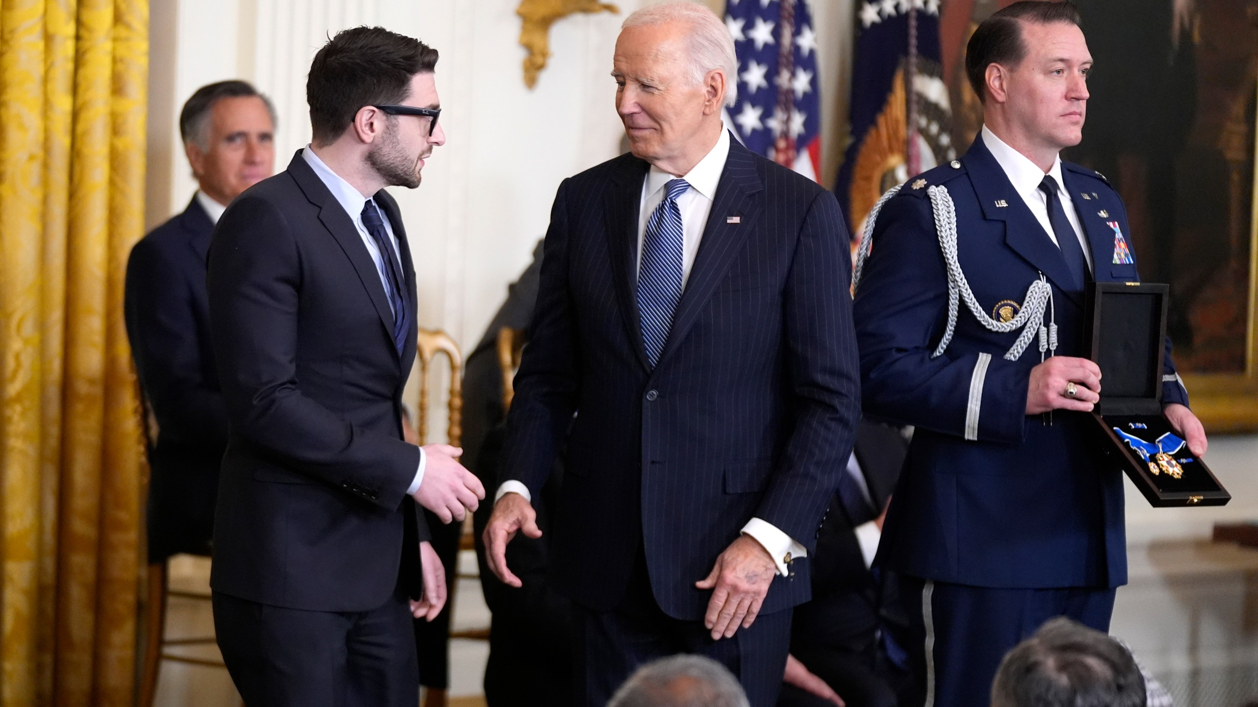 President Joe Biden, center, presents the Presidential Medal of Freedom, the Nation's highest civilian honor, to Alex Soros, left, on behalf of his father George Soros, in the East Room of the White House, Saturday, Jan. 4, 2025, in Washington. (AP Photo/Manuel Balce Ceneta)