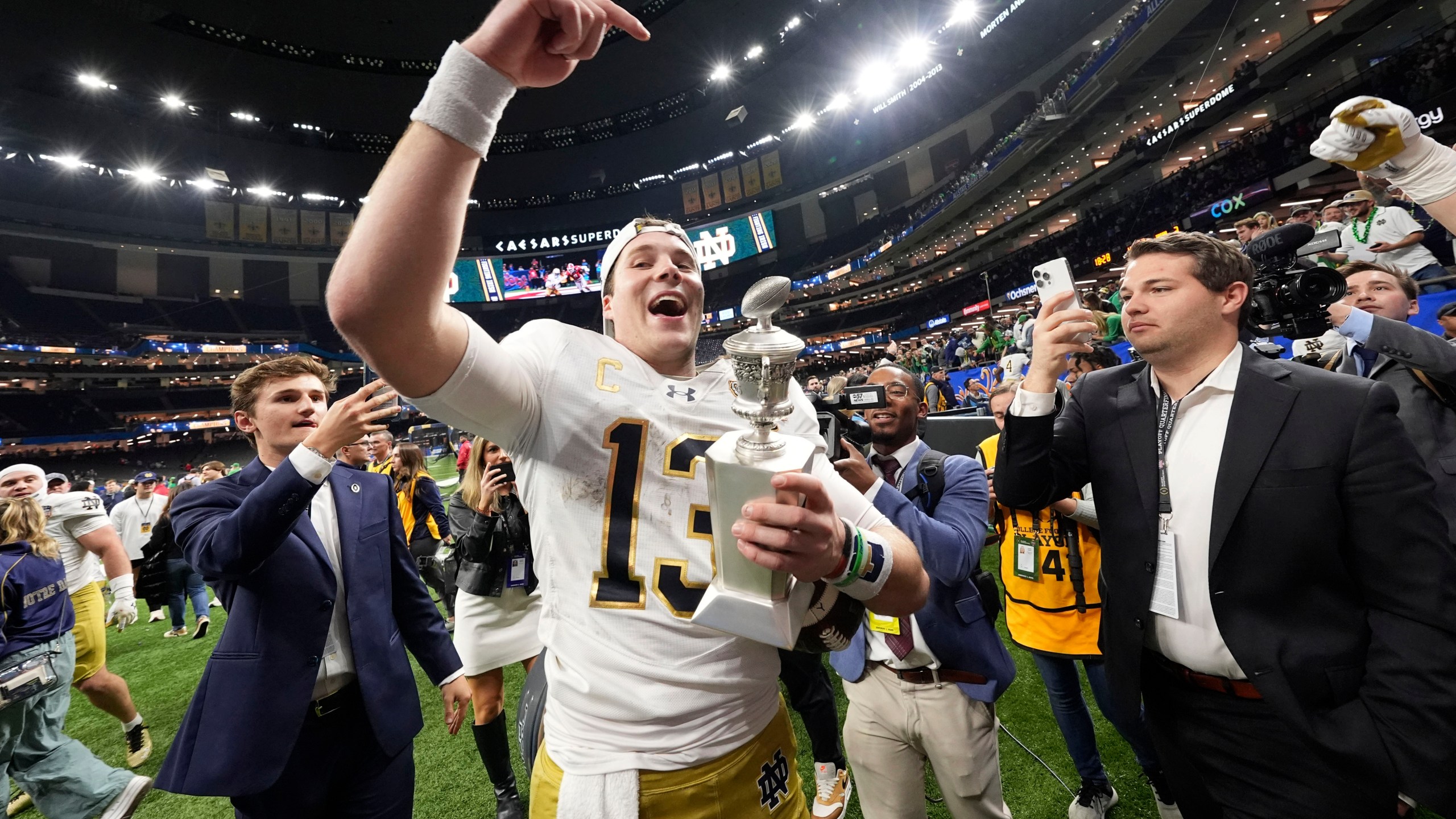 Notre Dame quarterback Riley Leonard (13) celebrates after a quarterfinal game against Georgia in a College Football Playoff, Thursday, Jan. 2, 2025, in New Orleans. (AP Photo/Gerald Herbert)