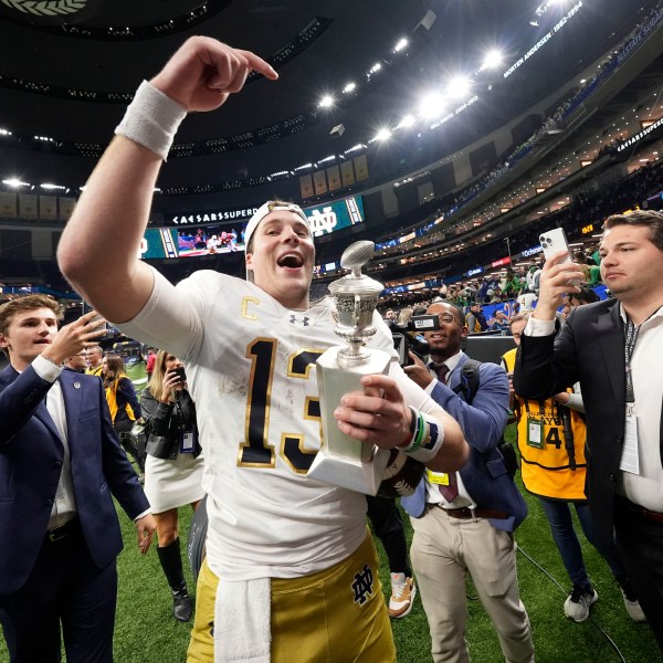 Notre Dame quarterback Riley Leonard (13) celebrates after a quarterfinal game against Georgia in a College Football Playoff, Thursday, Jan. 2, 2025, in New Orleans. (AP Photo/Gerald Herbert)