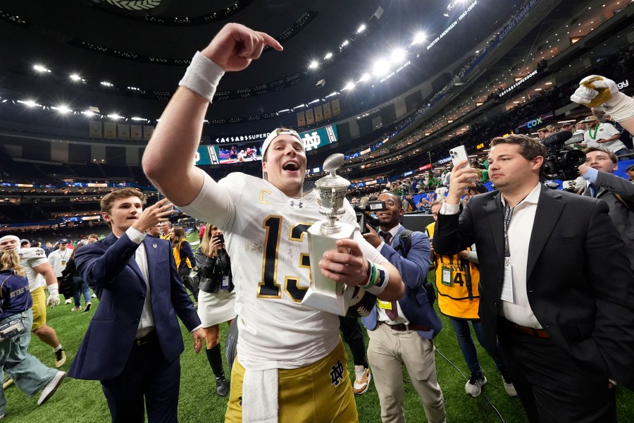 Notre Dame quarterback Riley Leonard (13) celebrates after a quarterfinal game against Georgia in a College Football Playoff, Thursday, Jan. 2, 2025, in New Orleans. (AP Photo/Gerald Herbert)