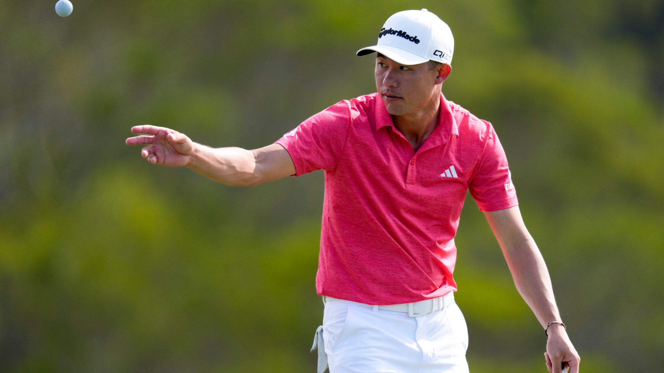 Collin Morikawa tosses his ball on the 17th green during the third round of The Sentry golf event, Saturday, Jan. 4, 2025, at Kapalua Plantation Course in Kapalua, Hawaii. (AP Photo/Matt York)