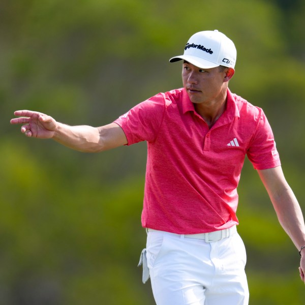 Collin Morikawa tosses his ball on the 17th green during the third round of The Sentry golf event, Saturday, Jan. 4, 2025, at Kapalua Plantation Course in Kapalua, Hawaii. (AP Photo/Matt York)