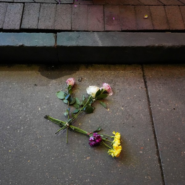 Flowers lie in the street at the site of a deadly truck attack on New Year's Day in New Orleans, Friday, Jan. 3, 2025. (AP Photo/Gerald Herbert)