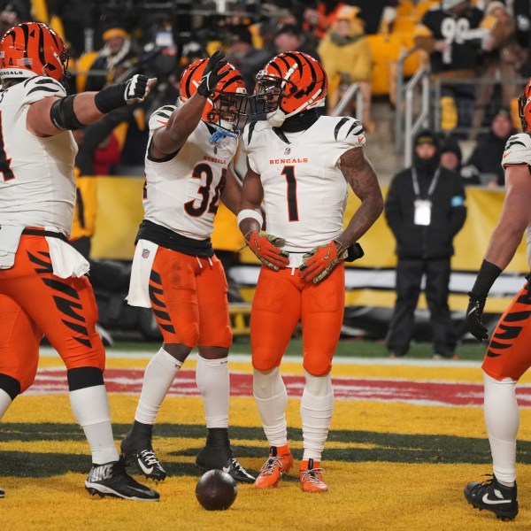 Cincinnati Bengals wide receiver Ja'Marr Chase (1) celebrates scoring a touchdown with center Ted Karras (64) and running back Khalil Herbert (34) during the first half of an NFL football game against the Pittsburgh Steelers in Pittsburgh, Saturday, Jan. 4, 2025. (AP Photo/Gene J. Puskar)