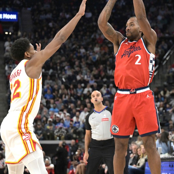 Los Angeles Clippers forward Kawhi Leonard (2) shoots over Atlanta Hawks forward De'Andre Hunter during the second half of an NBA basketball game Saturday, Jan. 4, 2025, in Los Angeles. (AP Photo/Jayne-Kamin-Oncea)